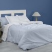 Dúo funda nórdica + almohada Greta azul escena de cama