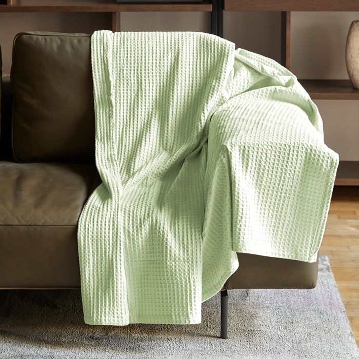 Plaid de Algodón Banús crema sobre sofá